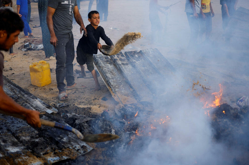Palestinci gase vatru na mjestu izraelskog napada u Rafi, Foto: Rojters