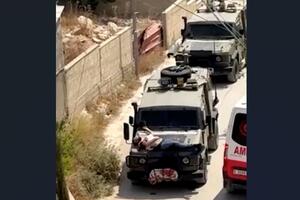 Izraelska vojska privezala ranjenog Palestinca za prednji dio...